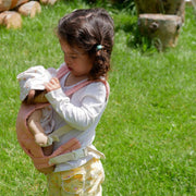 A qulited rose Olli Ella Doll Carrier with padded straps designed for carrying dolls.